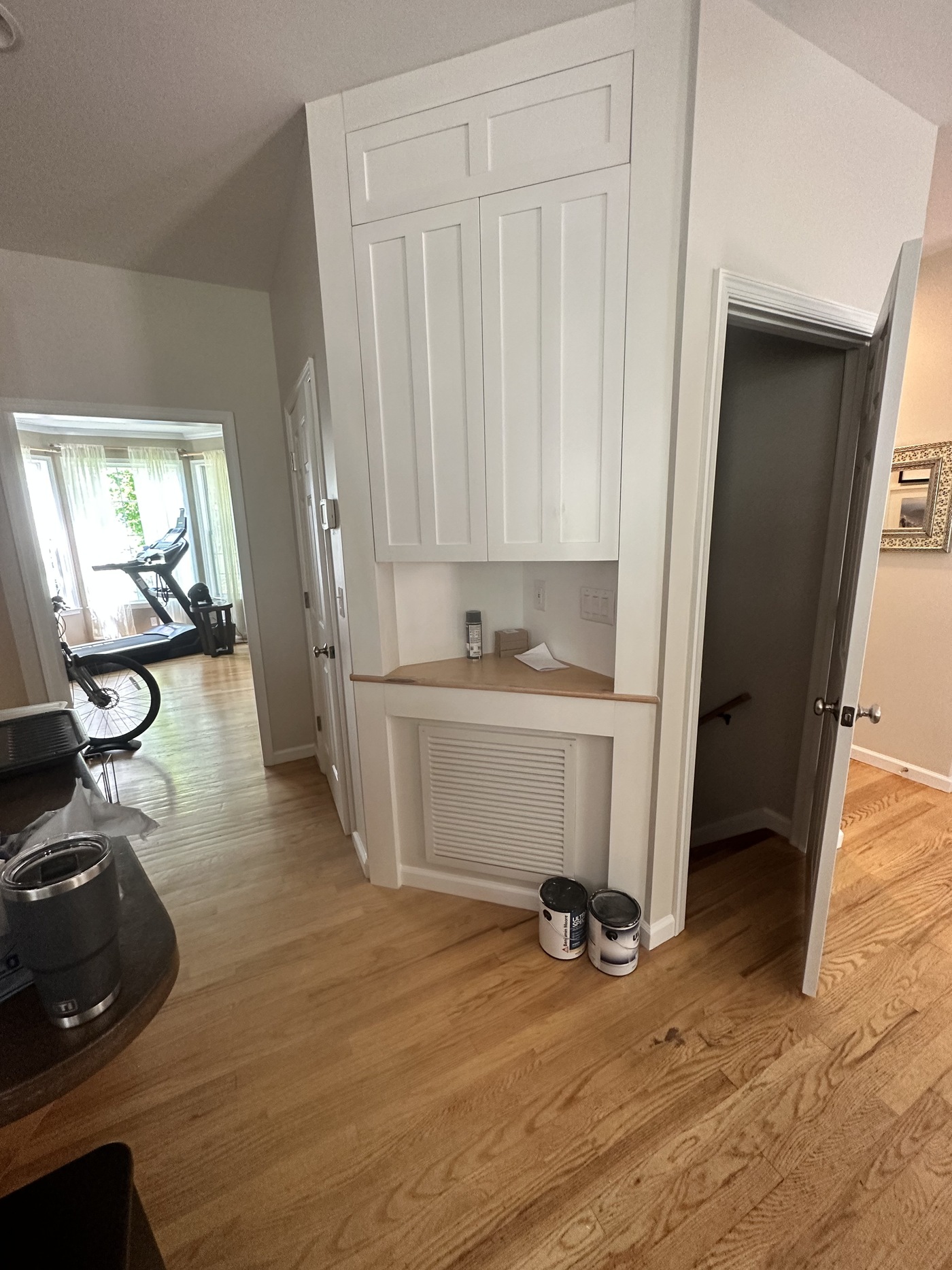 Custom-built painted cabinetry nook with hardwood flooring