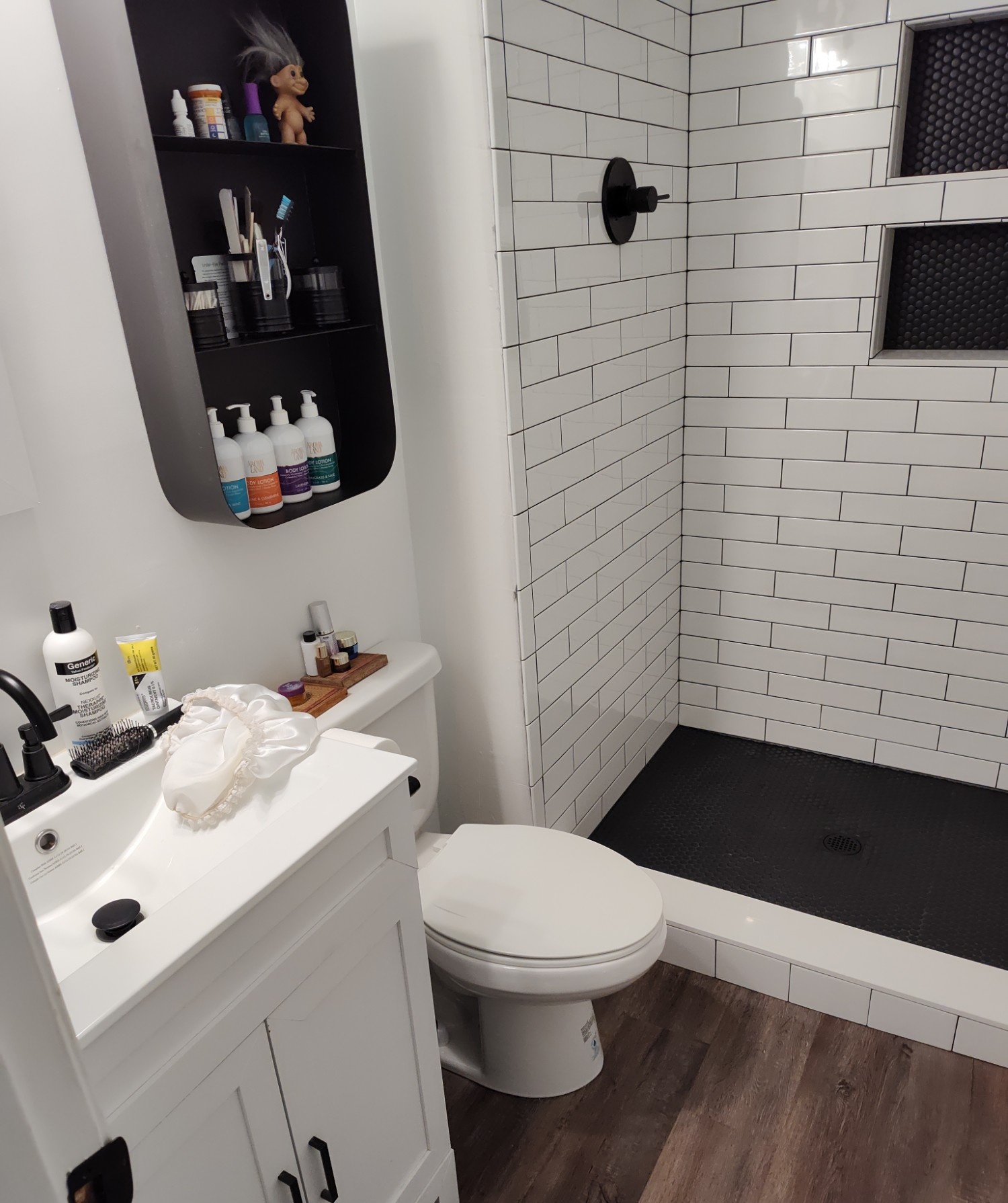 Full bathroom remodel with subway tile shower and white vanity