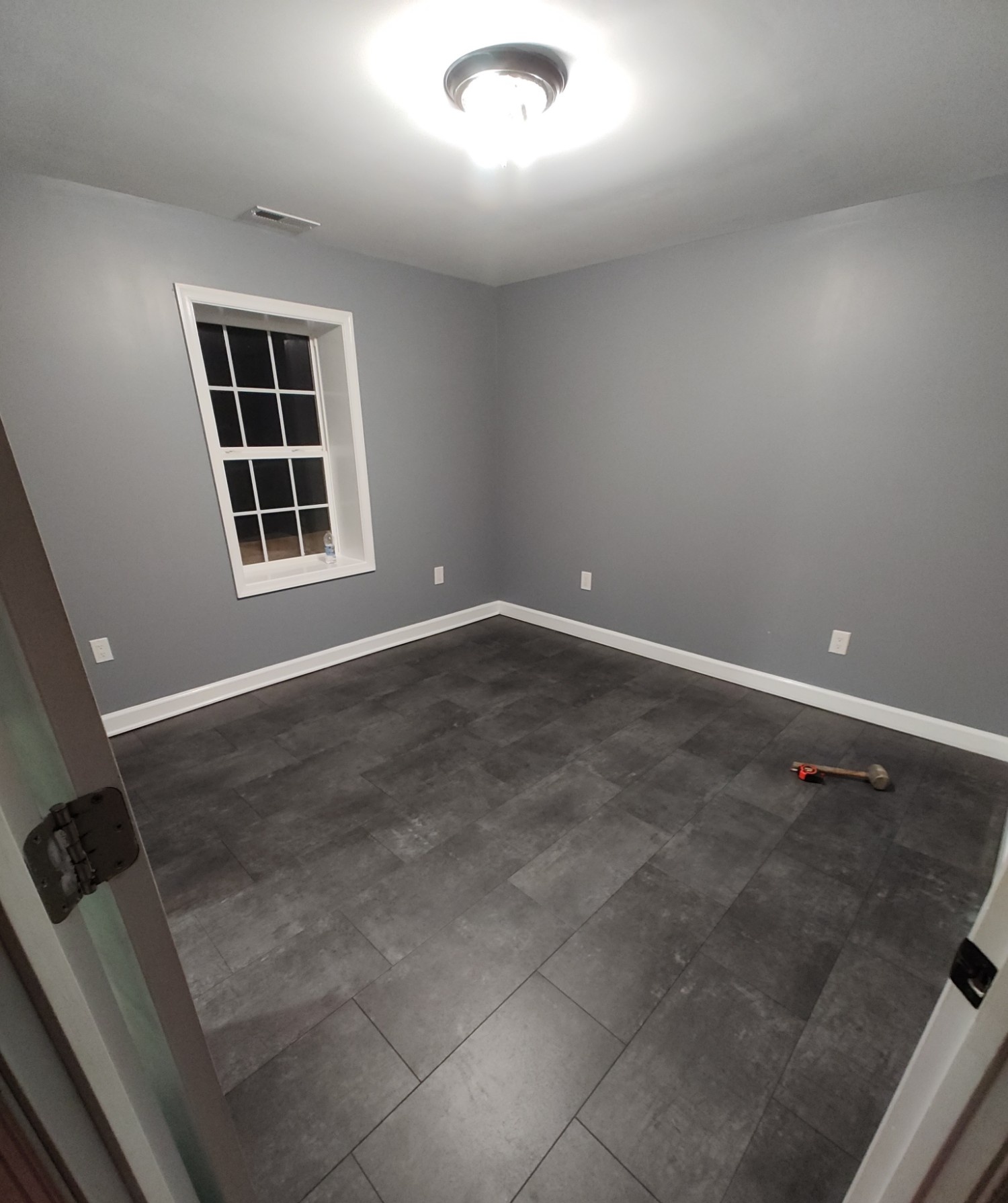 Room finished with dark tile flooring