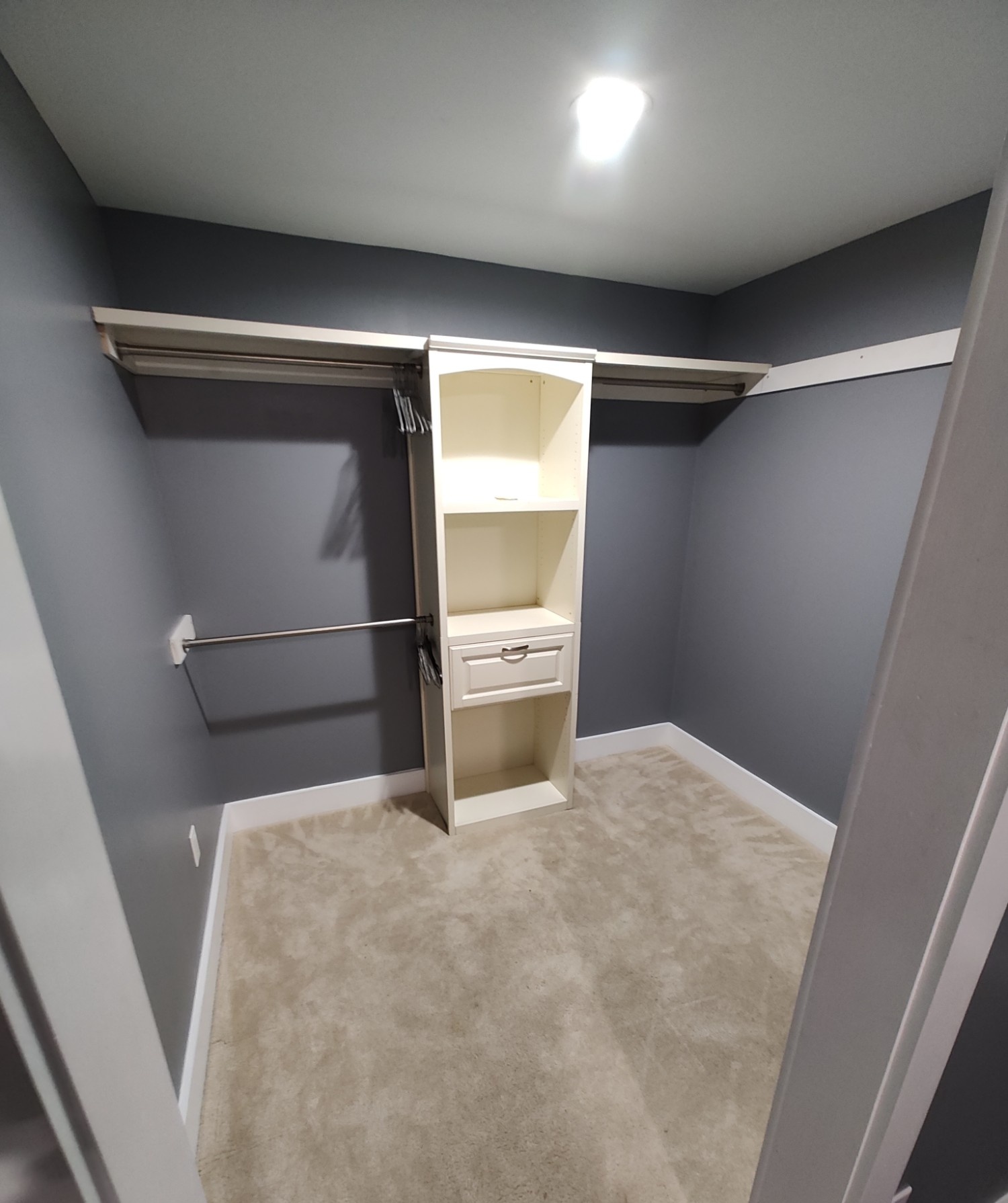 Custom-built closet shelving finished in white