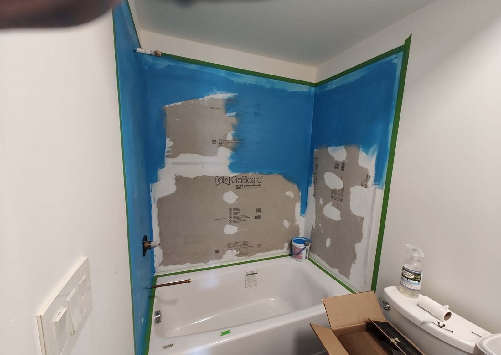 Blue waterproofing membrane applied over GoBoard before tiling
