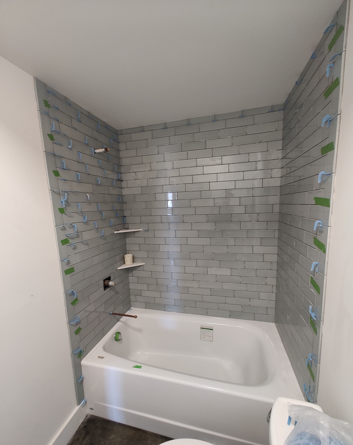 Finished grey subway tile shower and tub combo
