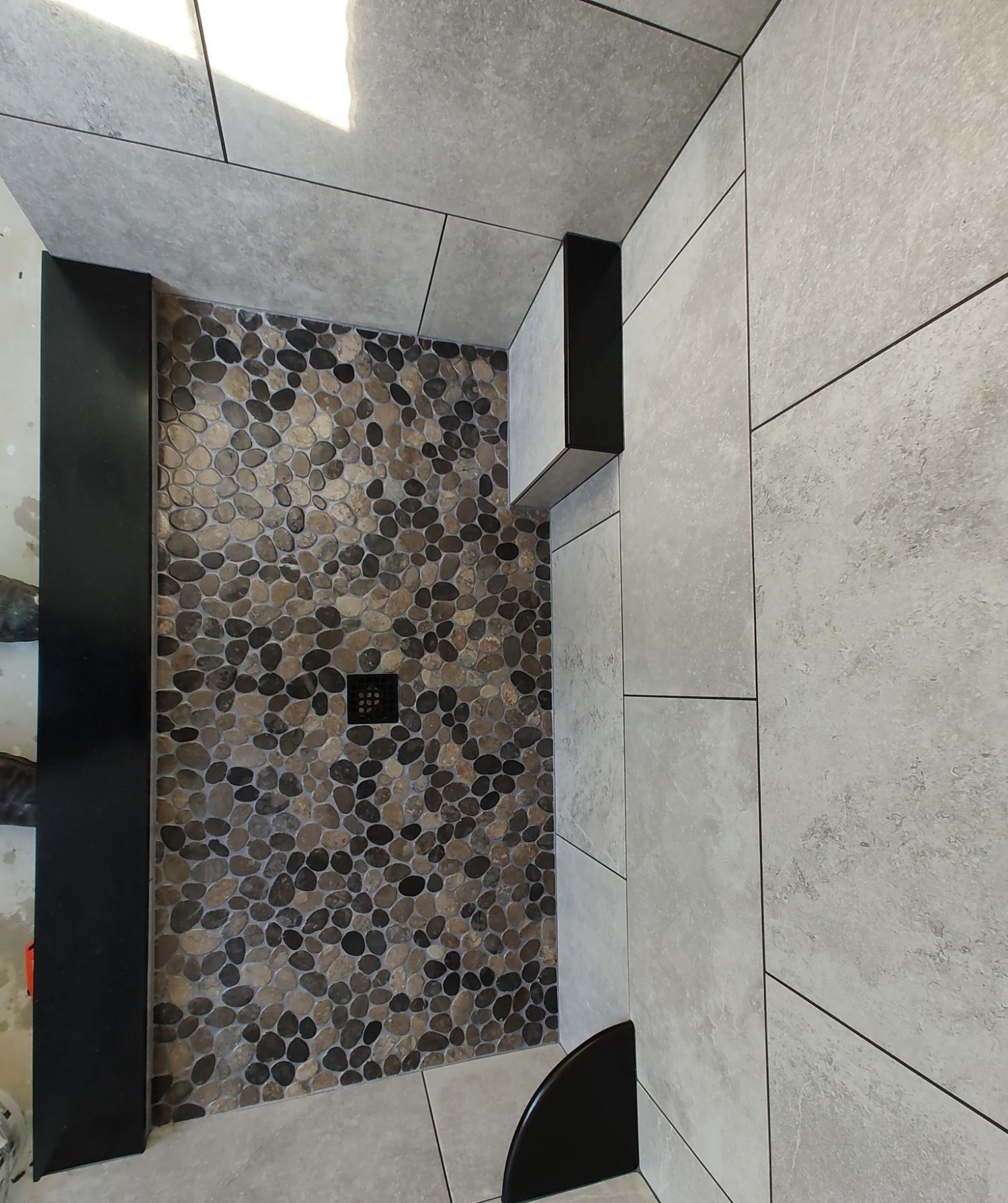 River pebble shower floor, top-down view