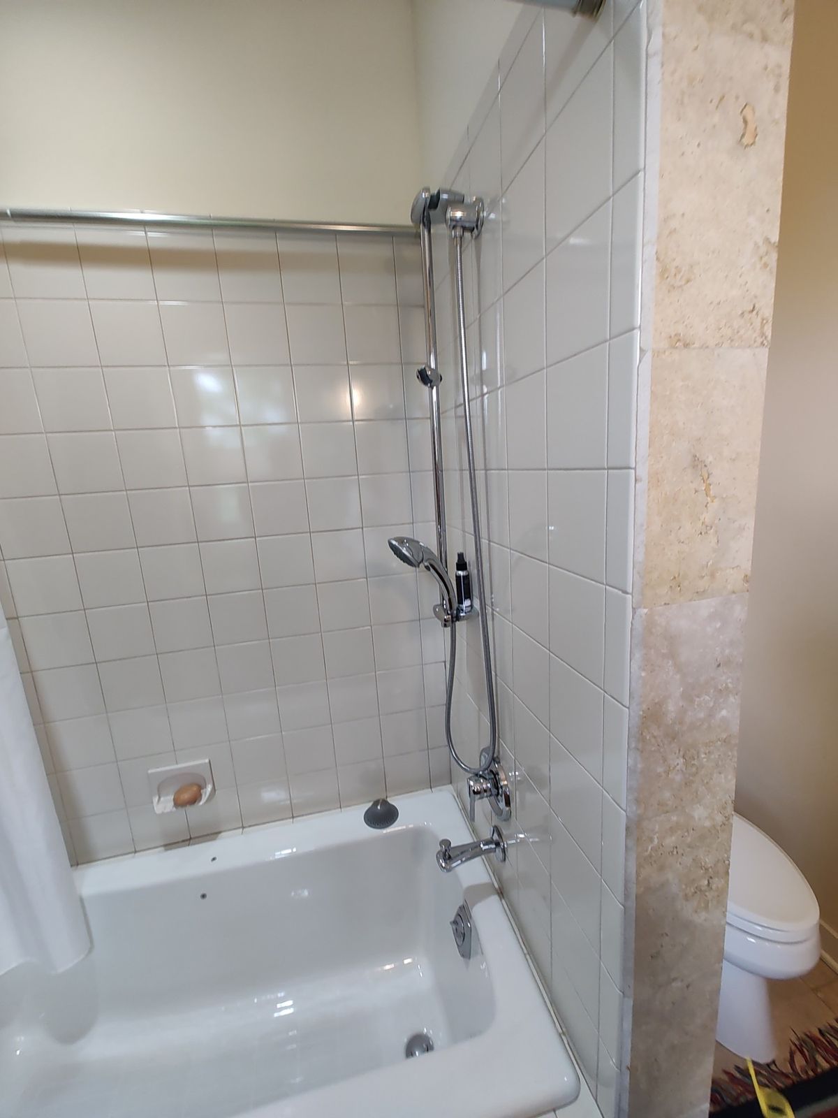 Tub and tile shower surround with slide-bar handheld shower head
