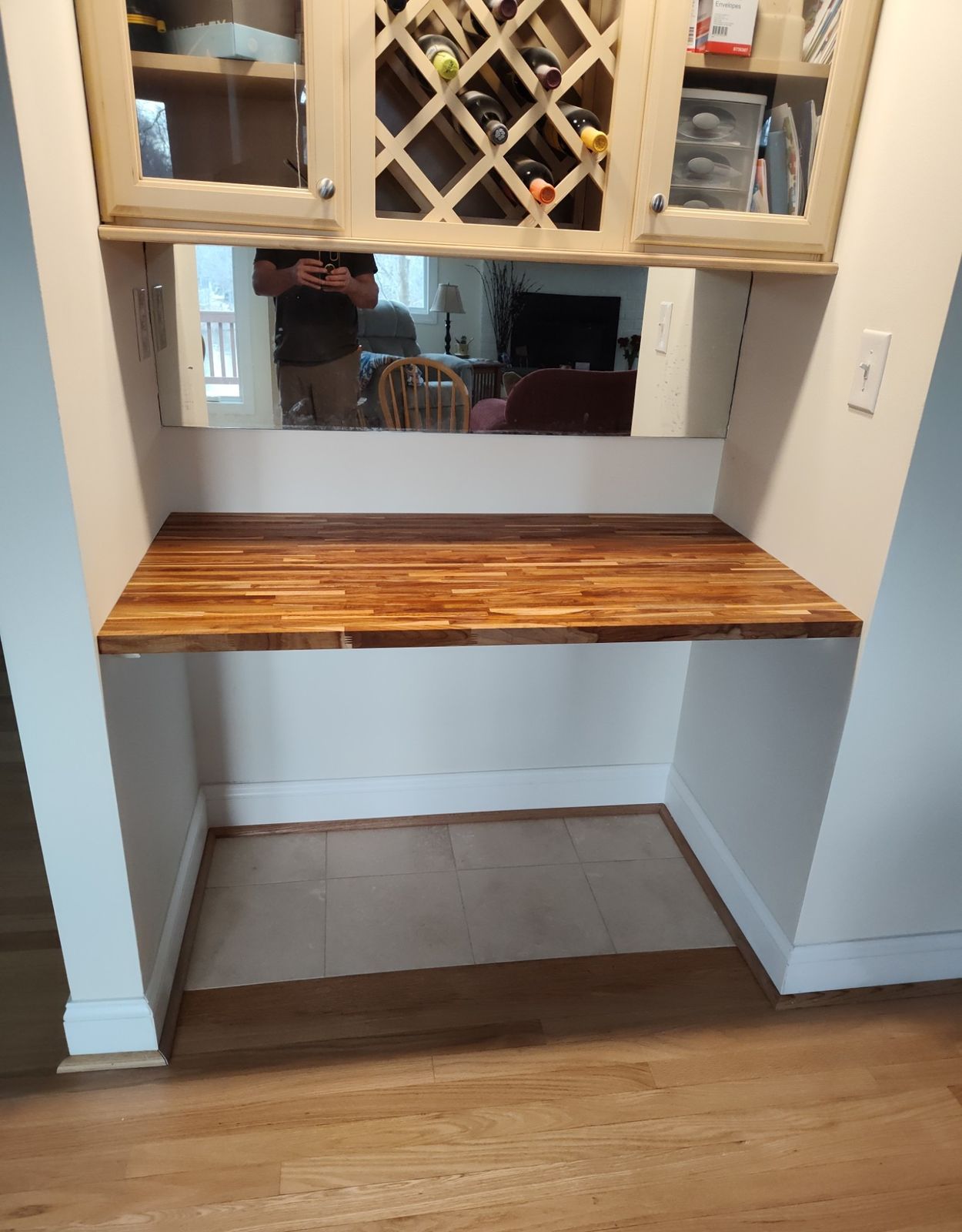 Built-in wine rack cabinetry over a butcher block counter nook