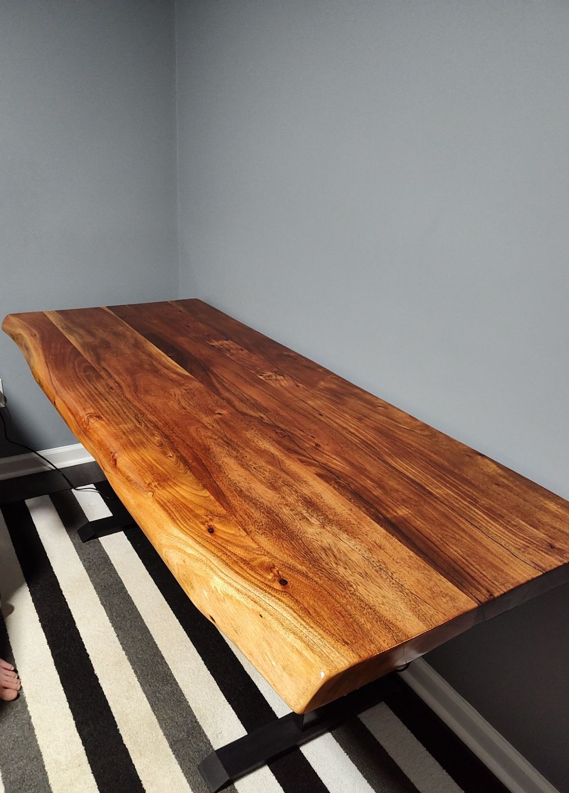 Custom live-edge walnut table with black steel base